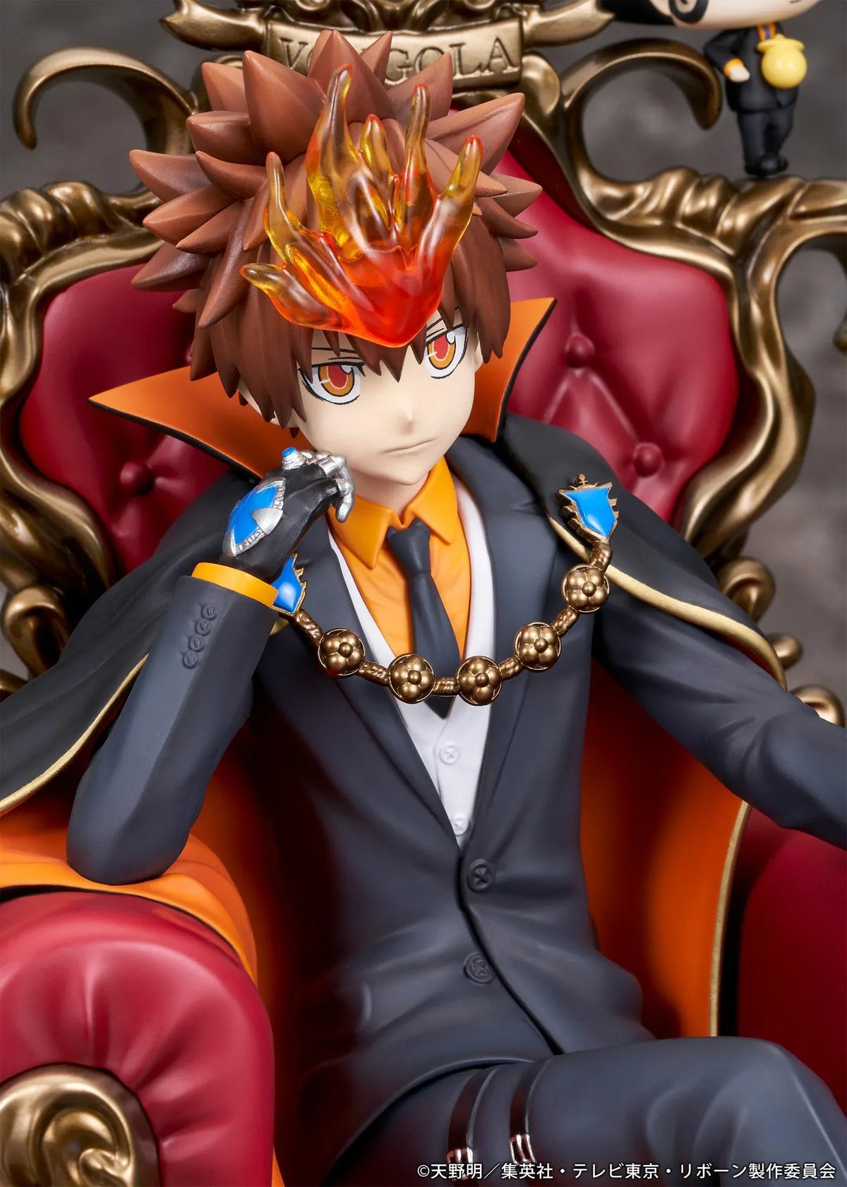 REBORN! Tsunayoshi Sawada & Reborn Scale Figure featuring Tsuna with spiky brown hair, a fiery Dying Will Flame, black suit, and orange-lined cape seated on an ornate golden throne with red upholstery, accompanied by Reborn in his signature fedora.