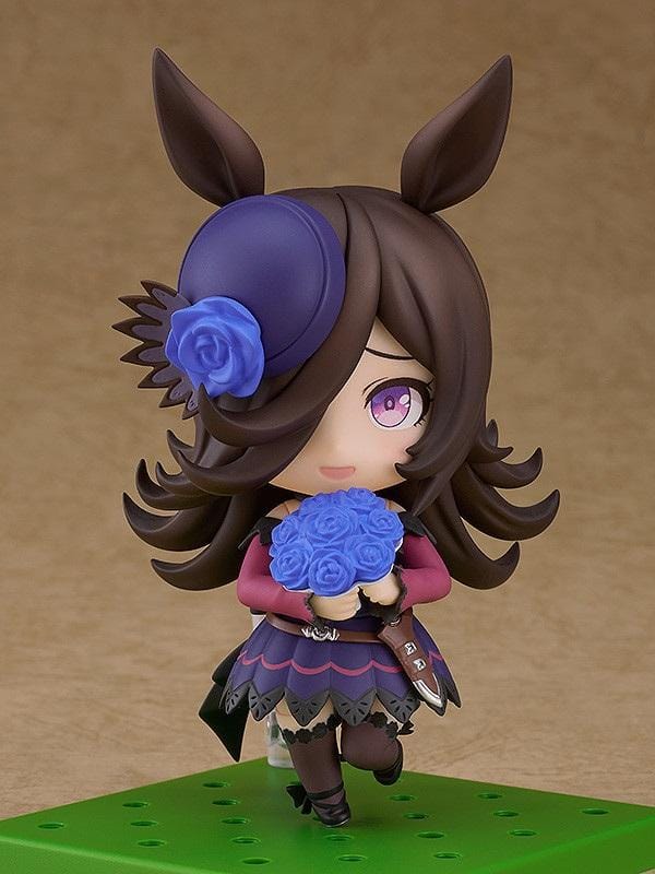 Umamusume Pretty Derby Nendoroid Rice Shower Figure (Rerelease) featuring a brown-haired horse girl with purple eyes, a miniature hat decorated with a blue rose, and an elegant purple and black racing outfit.