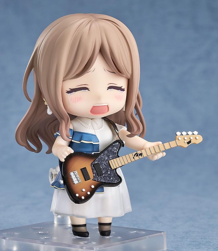 Nendoroid figure of Soyo Nagasaki from BanG Dream! holding a sunburst bass guitar, wearing a blue dress with a white skirt and black shoes.