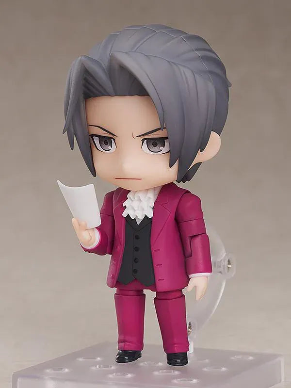 Ace Attorney Miles Edgeworth Nendoroid rerelease figure wearing a burgundy suit and pointing beside a Japanese Objection effect part.