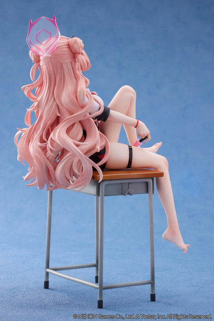 Blue Archive Kirara figure with long pink hair, black horns, and a pink halo, seated on a classroom desk beside nail polish bottles.