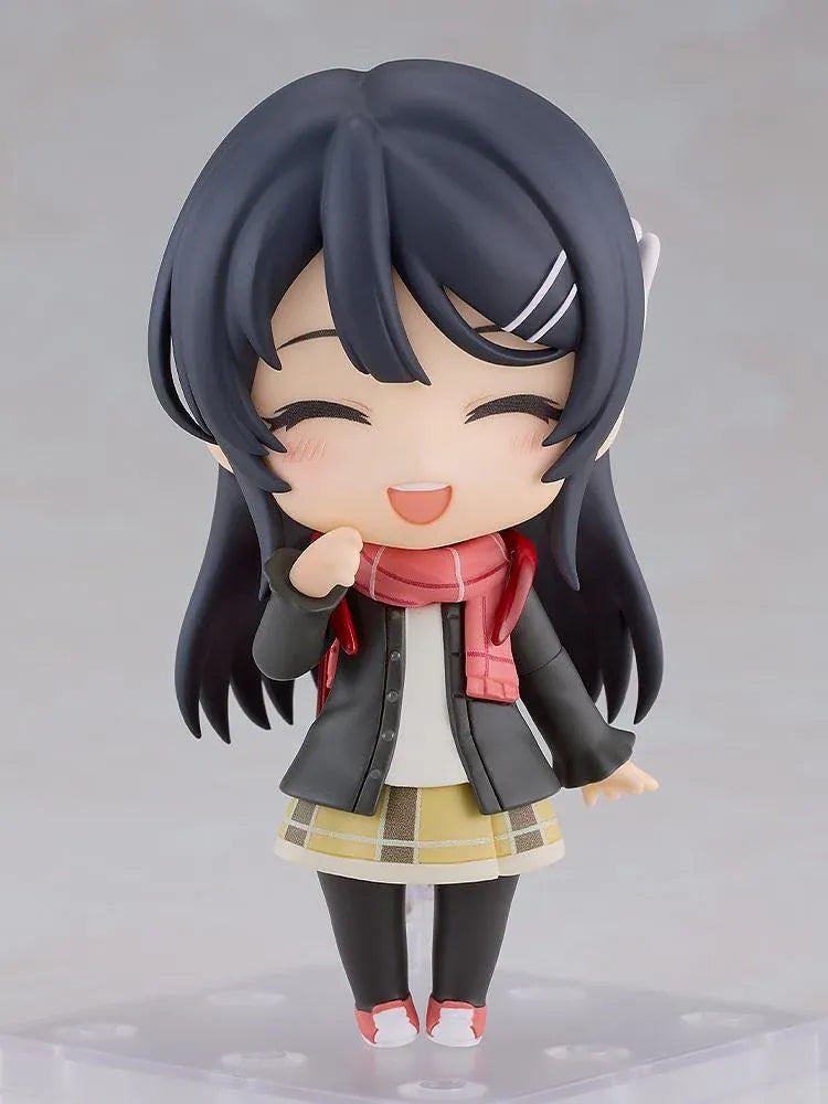Rascal Does Not Dream Series Nendoroid Knapsack Kid Figure featuring a black-haired anime girl with blue eyes wearing a dark jacket, pink scarf, yellow plaid skirt, black tights, and pink sneakers while carrying a red backpack.