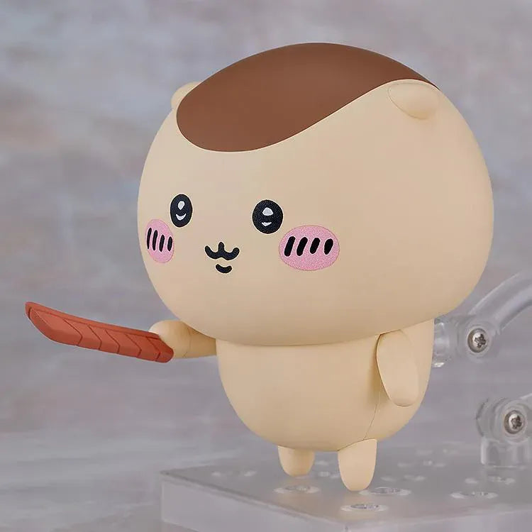 Chiikawa Nendoroid Kurimanju Figure featuring a round beige character with a chestnut-brown head, rosy pink cheeks, expressive black eyes, an open mouth, tiny arms, and small feet.