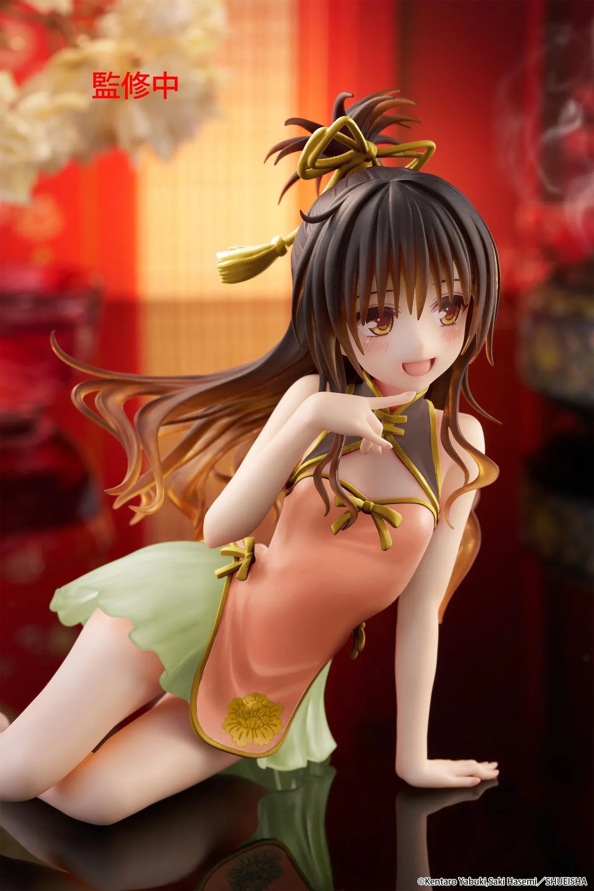 To Love-Ru Darkness Desktop Cute Mikan Yuki Chinese Dress Ver. Figure (Rerelease) featuring a brown-haired anime girl with golden eyes wearing an orange Chinese-style dress with gold trim, a light green ruffled skirt, and decorative hair ribbons in a seated pose.