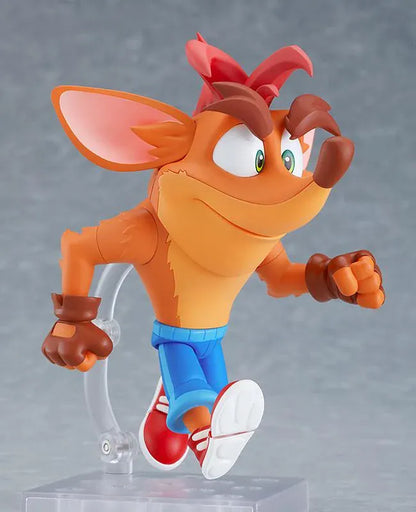 Crash Bandicoot Nendoroid rerelease figure with orange fur, a large grin, blue shorts, and red sneakers in an energetic pose.