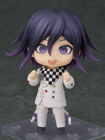 Nendoroid Kokichi Oma with purple hair, violet eyes, a black peaked cap and cape, and a white outfit, smiling with both arms extended.