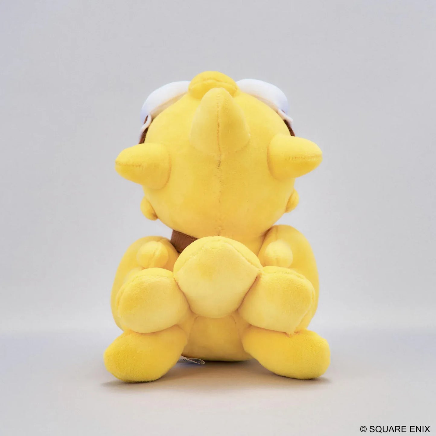 Final Fantasy Chocobo Chocobo and the Airship Ver. Plush with yellow Chocobo, pilot goggles, travel bag, blue embroidered eyes, and seated plush design