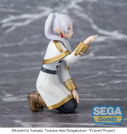 Perching figure of Frieren from Frieren: Beyond Journey’s End kneeling on a stone-like base, reaching forward to poke something, with long silver hair, elf ears, and a white-and-gold outfit.
