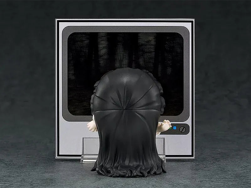 Nendoroid Sadako figure with long black hair covering her face, wearing a white dress and standing barefoot on a clear display base.