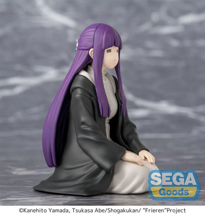 Perching figure of Fern from Frieren: Beyond Journey’s End kneeling calmly in robes, eyes closed in a binding spell pose, with long purple hair and a gray cloak.