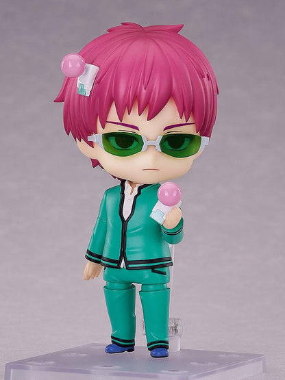 Kusuo Saiki Nendoroid with pink hair, pink-tipped head accessories, green glasses, and a teal school uniform, posed with one hand extended.