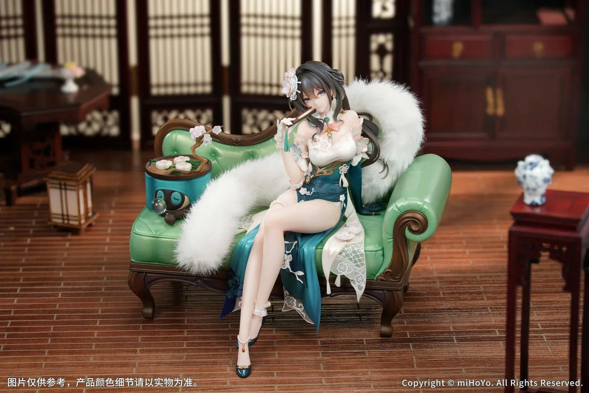 Ruan Mei Plumblossom Letter 1/7 scale figure wearing an elegant teal-and-white floral dress while seated on an ornate green sofa.