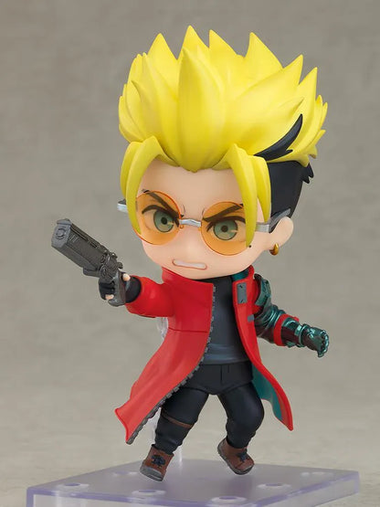 TRIGUN STARGAZE Vash the Stampede Nendoroid with spiky blond hair, orange glasses, a red coat, metallic teal mechanical arm, and raised handgun.