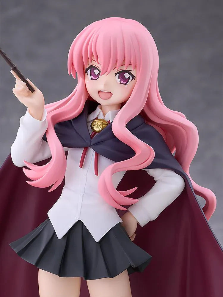 POP UP PARADE Louise L Size figure with flowing pink hair, a raised wand, white blouse, dark skirt, and a cape with burgundy lining.