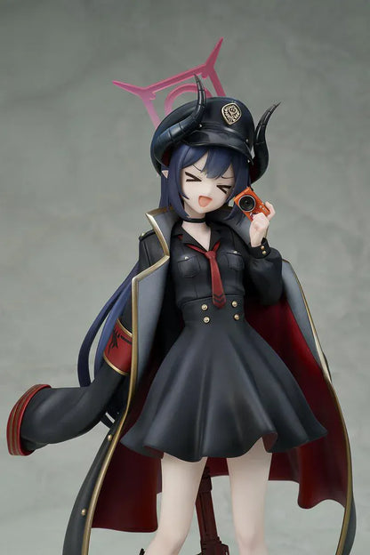 Blue Archive Chiaki 1/7 scale figure wearing dark uniform with long coat holding camera and rifle accessory.
