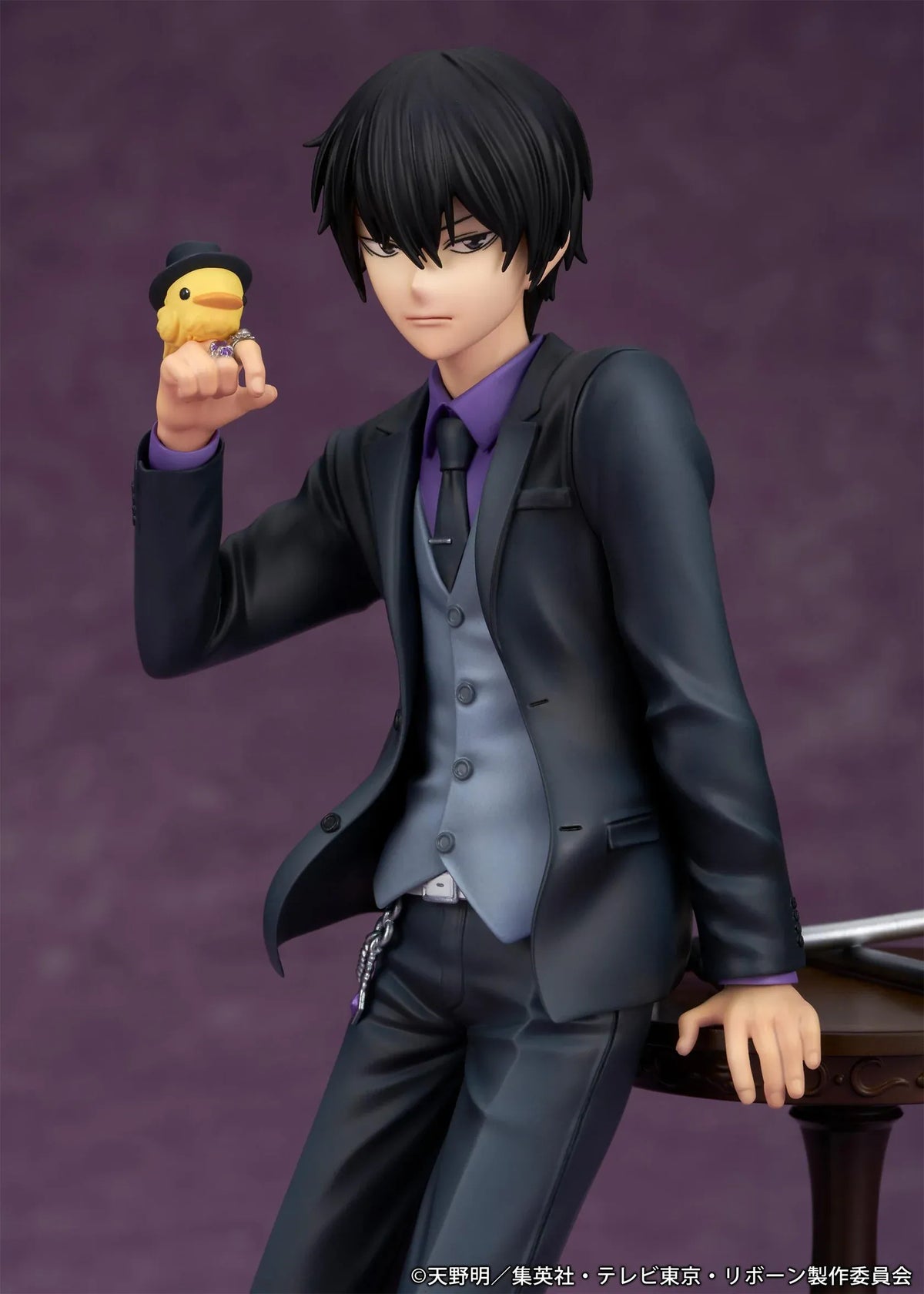 REBORN! Kyoya Hibari Scale Figure featuring a black-haired anime character wearing a black suit, purple shirt, gray vest, and tie, leaning against a wooden table with tonfa weapons while holding his yellow bird companion Hibird.