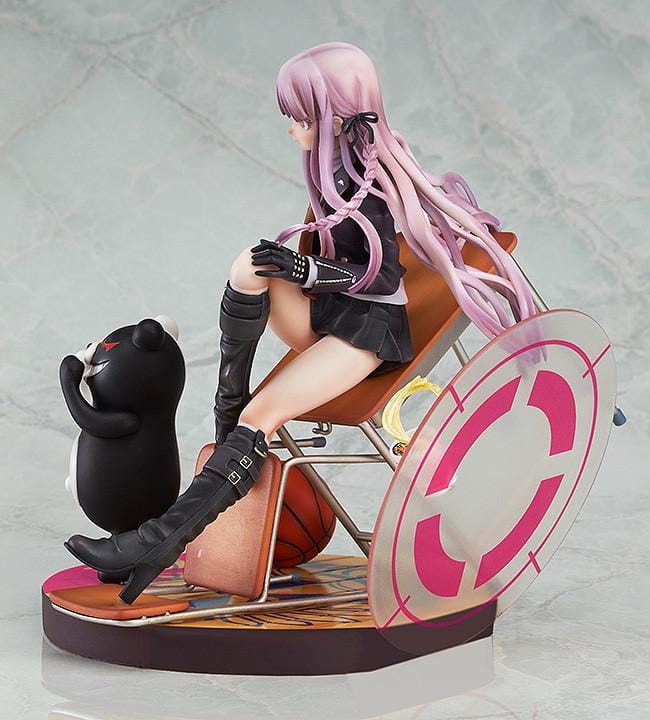 Kyoko Kirigiri 1/8 scale figure seated on a tilted classroom desk, with Monokuma, a basketball, and scattered furniture on a pink-accented base.