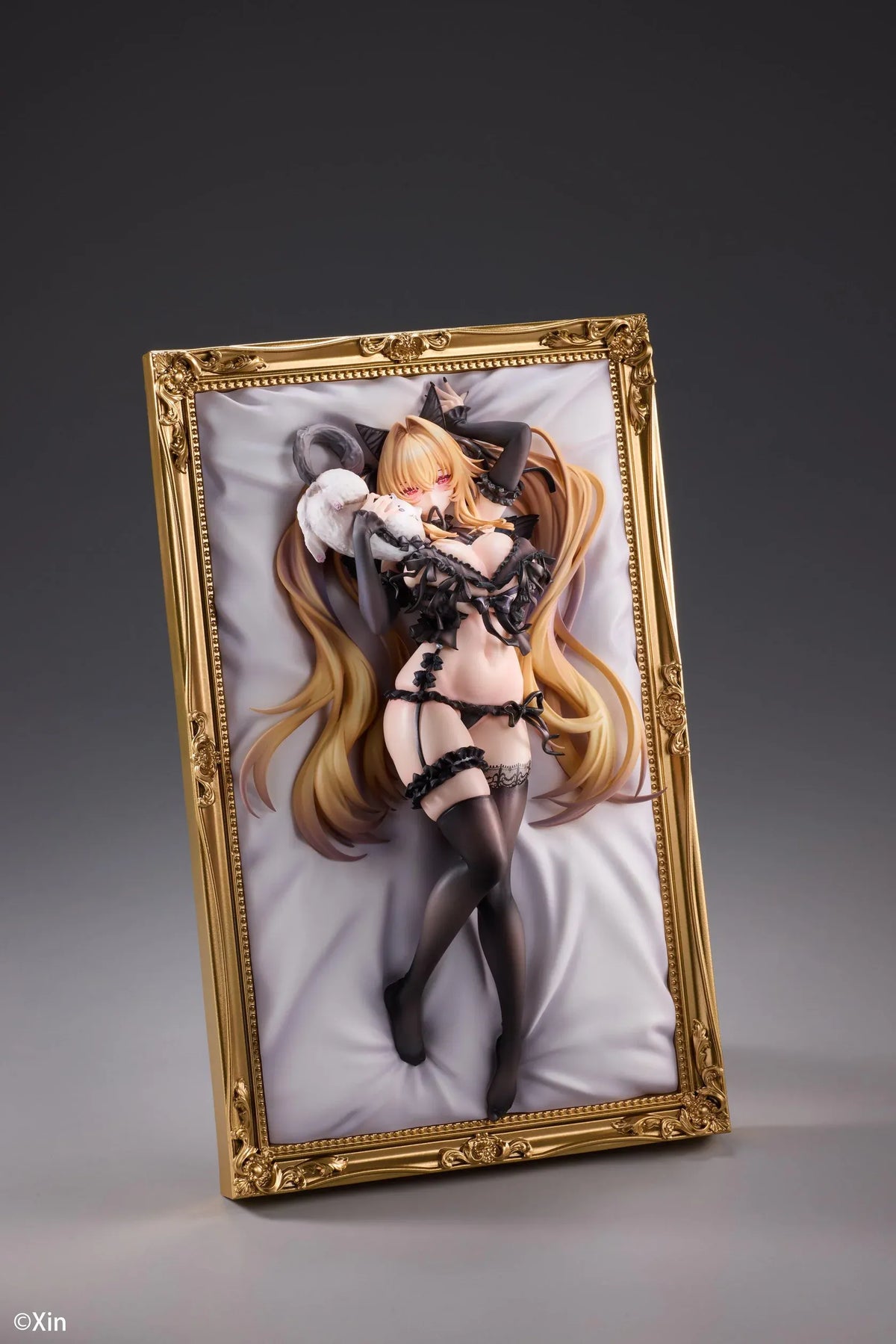 Stella Black Cat Ver. Deluxe Edition 1/7 Scale Figure illustrated by Xin, featuring a blonde-haired catgirl with red eyes, black lace lingerie, cat ears, and thigh-high stockings displayed in an ornate golden frame with a matching illustrated wall scroll.