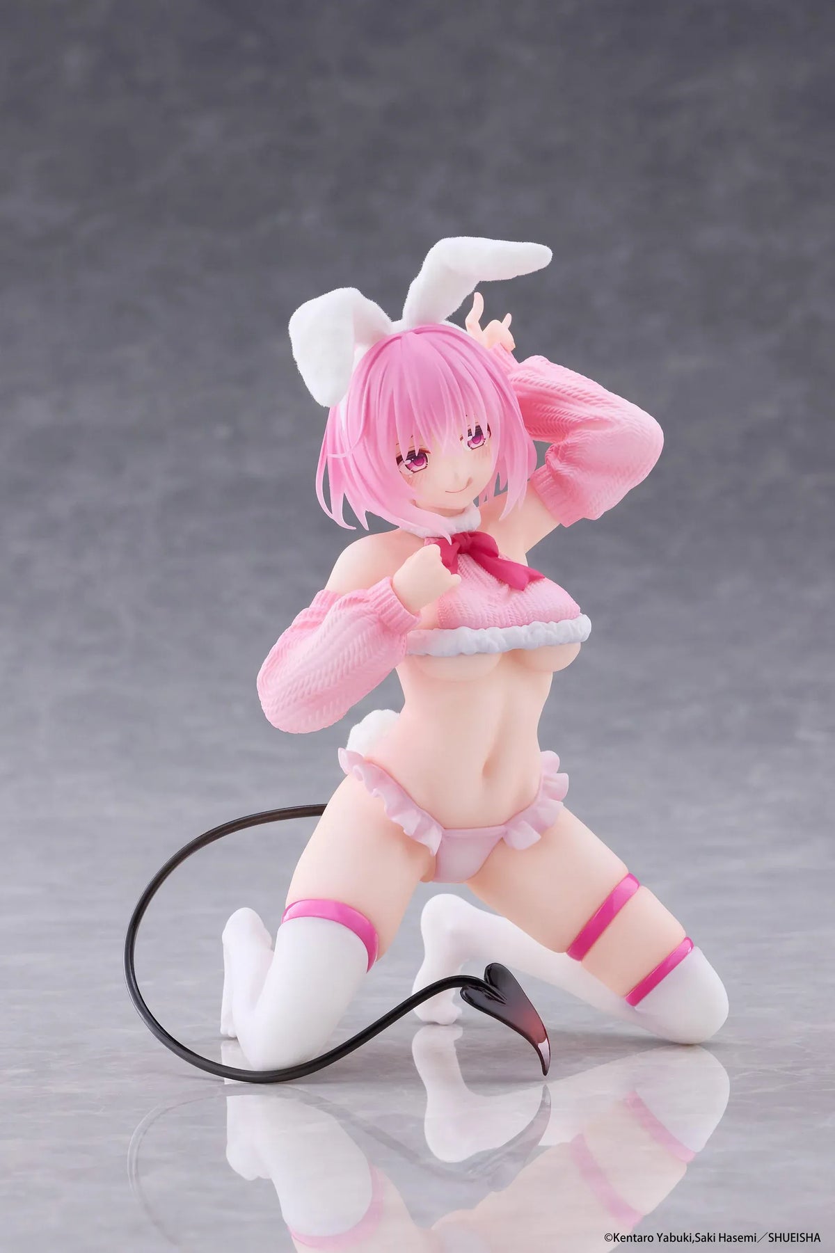 To Love-Ru Darkness MOFLOCK Momo Fluffy Bunny Ver. Figure featuring a pink-haired anime girl with pink eyes, white bunny ears, a pink fluffy bunny outfit, matching sleeves, white thigh-high stockings, and a black devil tail in a playful kneeling pose.