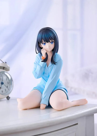 GRIDMAN UNIVERSE Rikka Takarada Pajamas Ver. figure seated in light blue pajamas, with dark hair, blue eyes, and an orange wrist scrunchie.