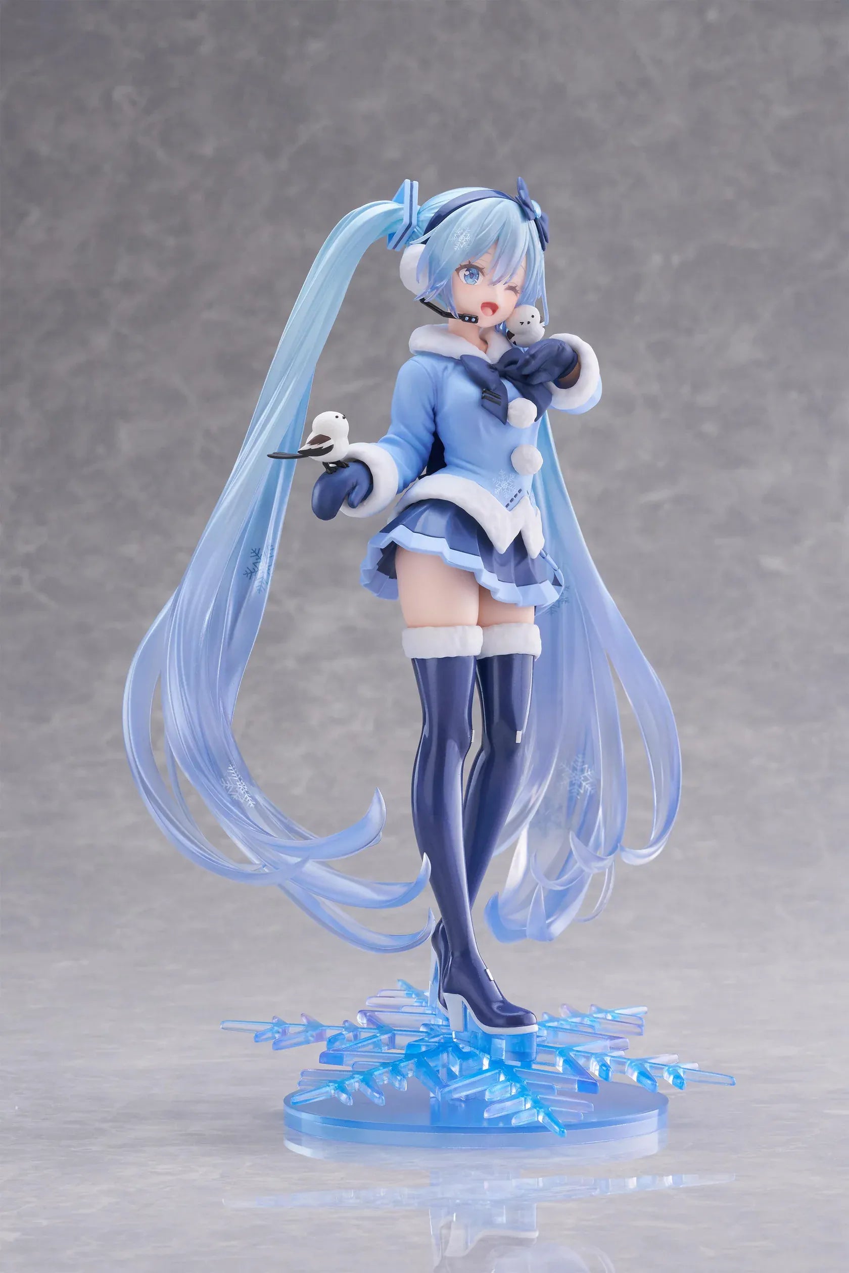 Vocaloid AMP+ Snow Miku All Stars 2012 Ver. Figure with icy blue twin-tails, winter outfit, bird details, and snowflake display base