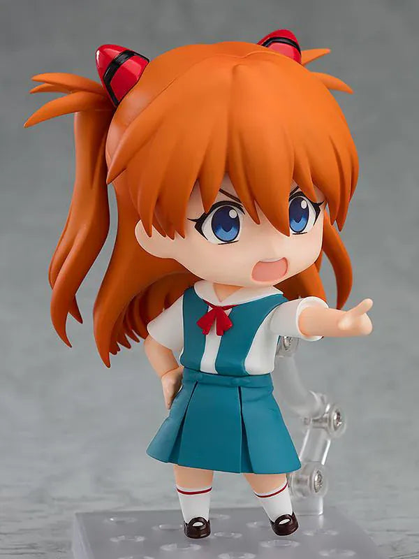 Rebuild of Evangelion Nendoroid Asuka Shikinami Langley Figure Rerelease featuring Asuka with orange twin tails, blue eyes, school uniform, and cheerful waving pose.