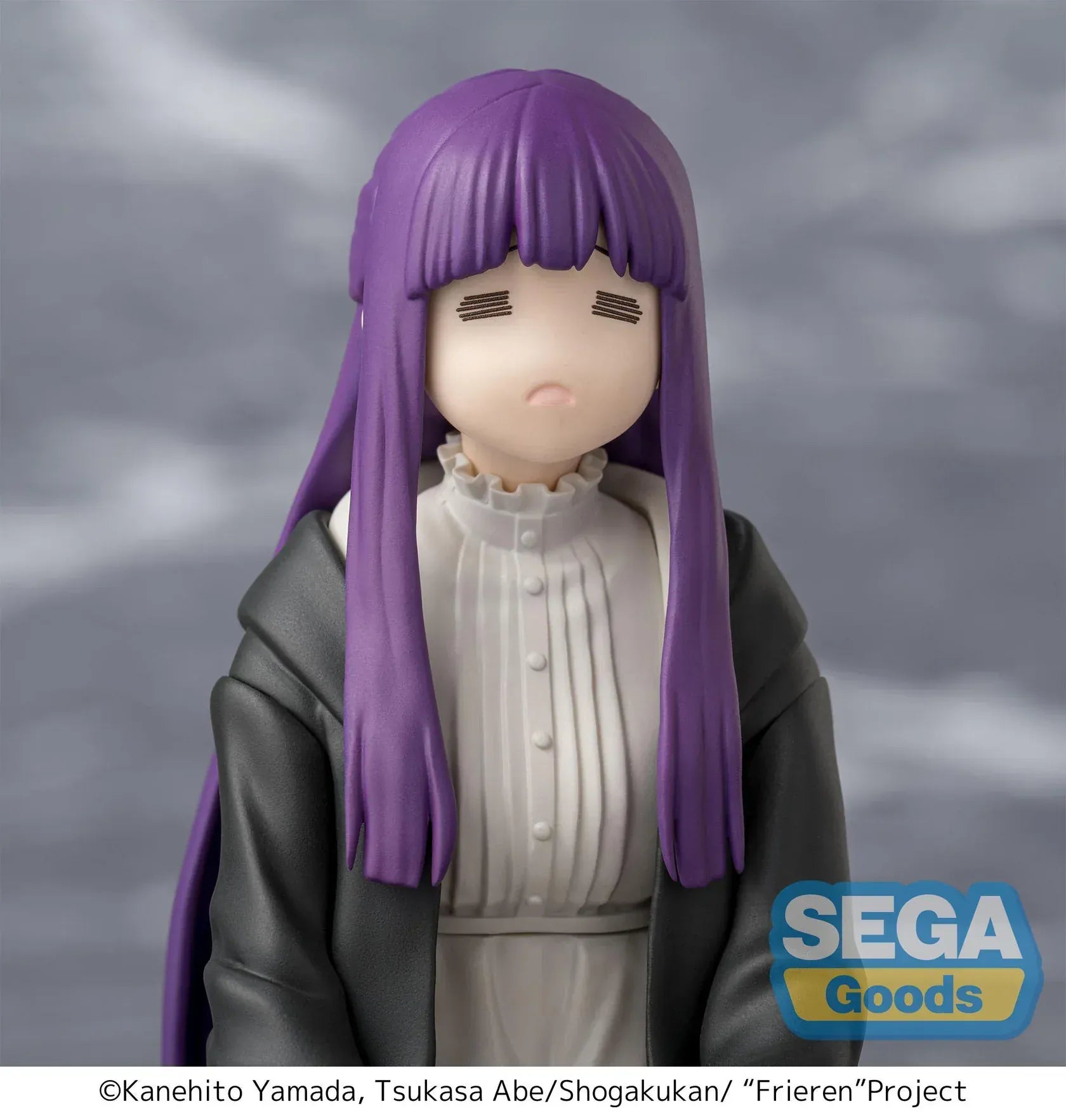 Perching figure of Fern from Frieren: Beyond Journey’s End kneeling calmly in robes, eyes closed in a binding spell pose, with long purple hair and a gray cloak.