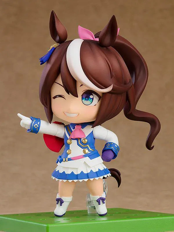 Umamusume Pretty Derby Nendoroid Tokai Teio rerelease figure with brown hair, a white forelock, pink bow, and blue-and-white racing uniform.