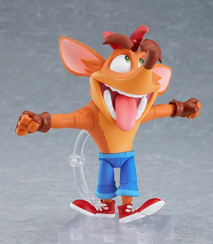 Crash Bandicoot Nendoroid rerelease figure with orange fur, a large grin, blue shorts, and red sneakers in an energetic pose.
