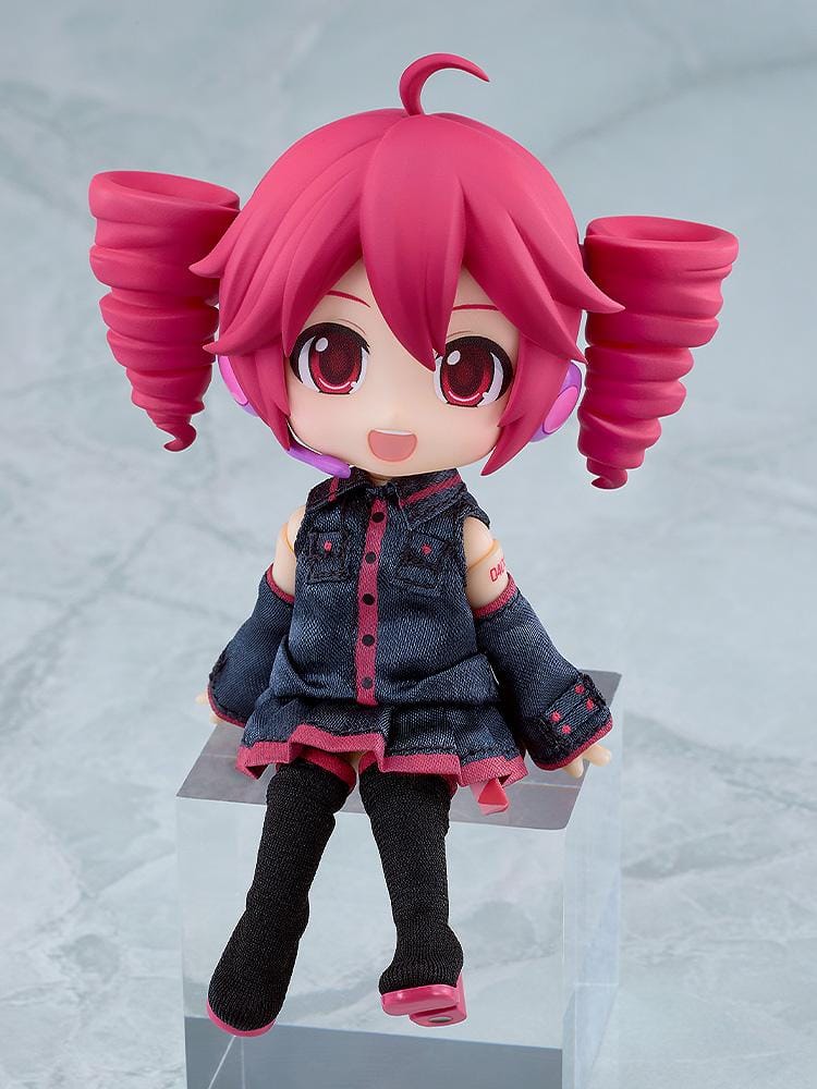 Kasane Teto Nendoroid Doll with pink drill-shaped twin tails, a headset microphone, and a dark fabric outfit with pink trim, posed waving.