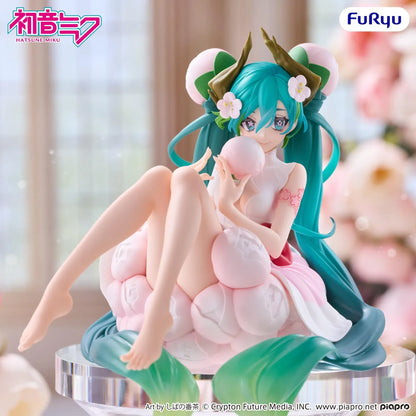 Hatsune Miku Flower Fairy White Plum Blossom Noodle Stopper figure seated among pale pink blossoms with flowing turquoise twin-tails.