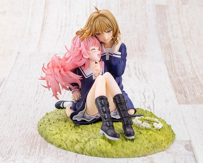 I Want to Love You Till Your Dying Day Sheena & Mimi 1/8 Scale Figure featuring pink-haired Sheena smiling with her eyes closed while leaning against blonde-haired Mimi. Both wear navy-blue school-inspired dresses and sit together on a textured grassy display base decorated with a white daisy flower crown.