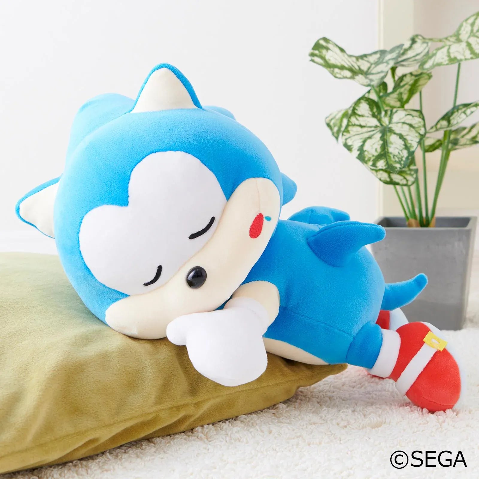 Sonic & Friends Sonic sleeping plush lying on his side with closed eyes, white gloves, and red shoes.