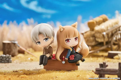 Spice and Wolf Mini Memory Lawrence and Holo chibi figure set sitting on a wooden crate base