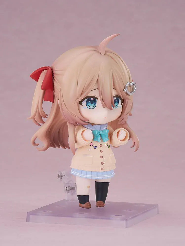 Neuro-sama Nendoroid figure with light brown hair, red ribbons, a heart hair clip, peach cardigan, turquoise bow, and a green turtle on her head.