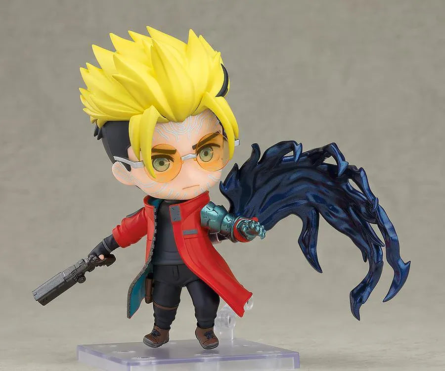 TRIGUN STARGAZE Vash the Stampede Nendoroid with spiky blond hair, orange glasses, a red coat, metallic teal mechanical arm, and raised handgun.