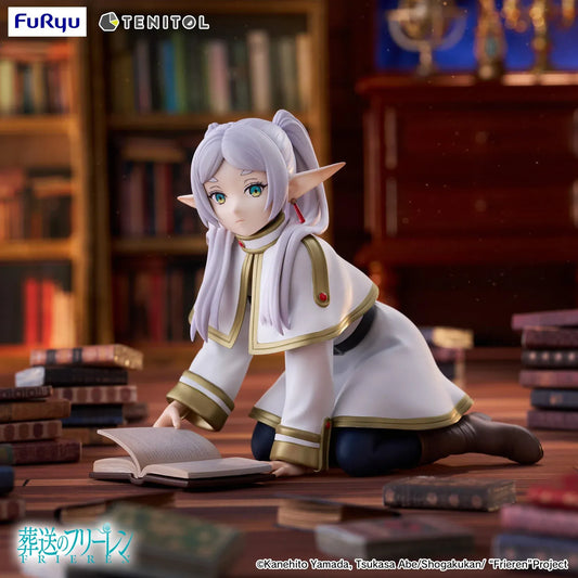TENITOL Frieren [petit] figure kneeling over an open book, wearing a white and gold outfit with silver twin tails, pointed ears, and brown boots.