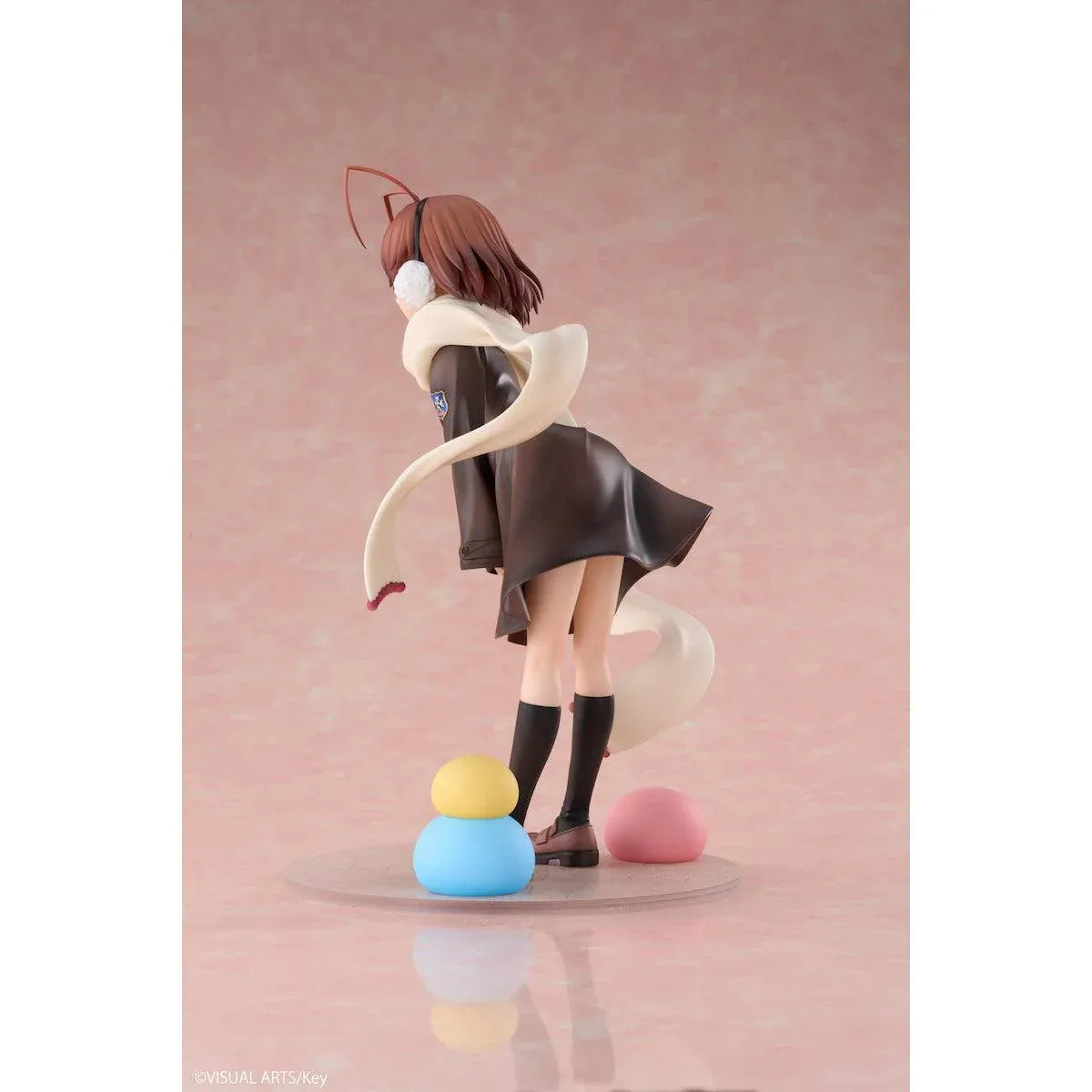 CLANNAD Nagisa Furukawa 1/6 Scale Figure featuring a smiling brown-haired anime girl wearing a dark school uniform, cream-colored scarf, white earmuffs, and black knee-high socks, surrounded by colorful Dango Daikazoku characters.