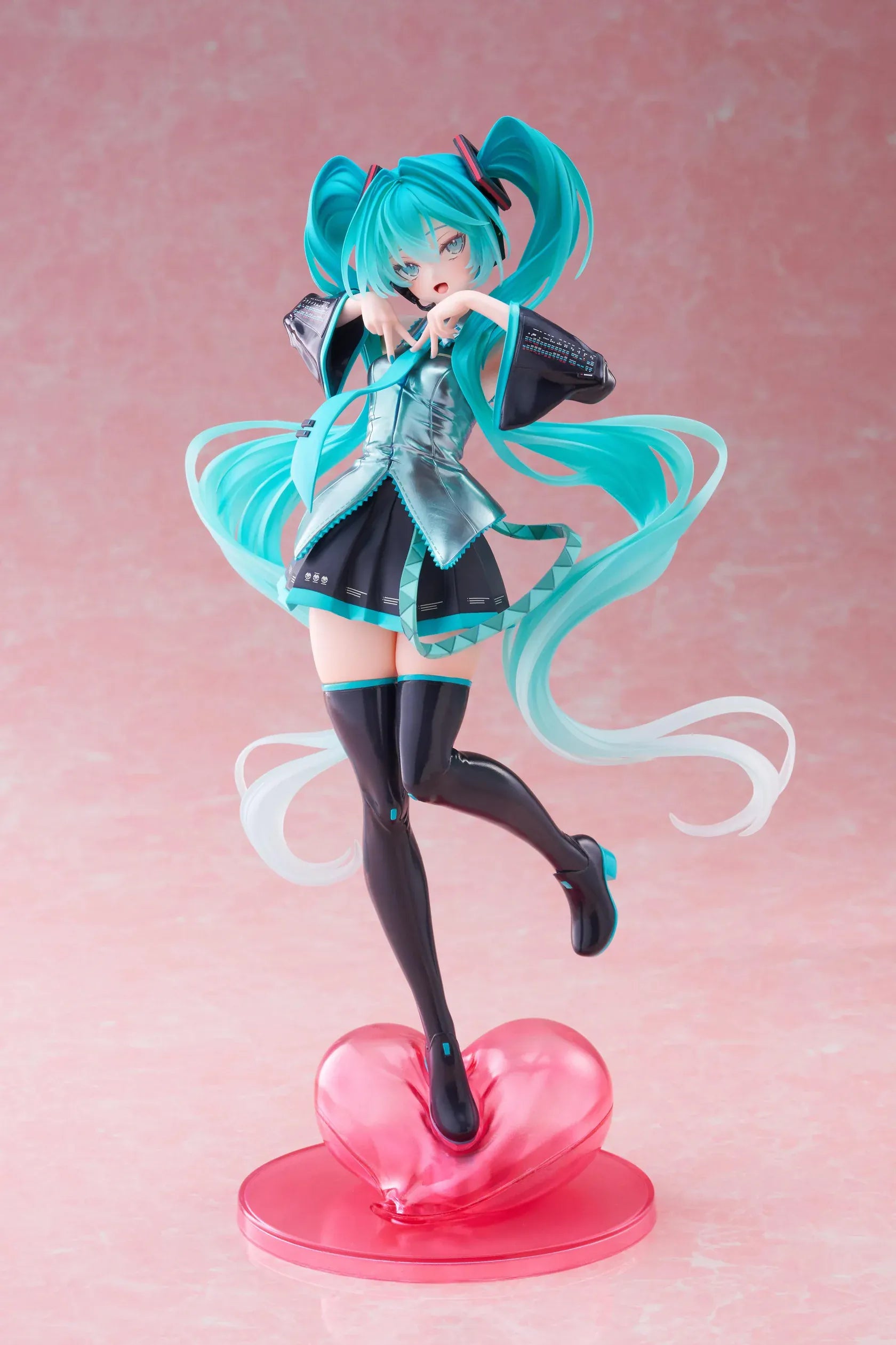 Hatsune Miku T-Most figure with flowing twin tails, classic Vocaloid outfit, and pink heart-shaped display base