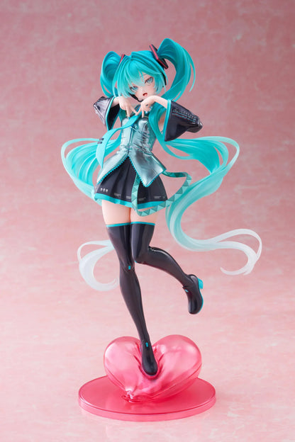 Hatsune Miku T-Most figure with flowing twin tails, classic Vocaloid outfit, and pink heart-shaped display base