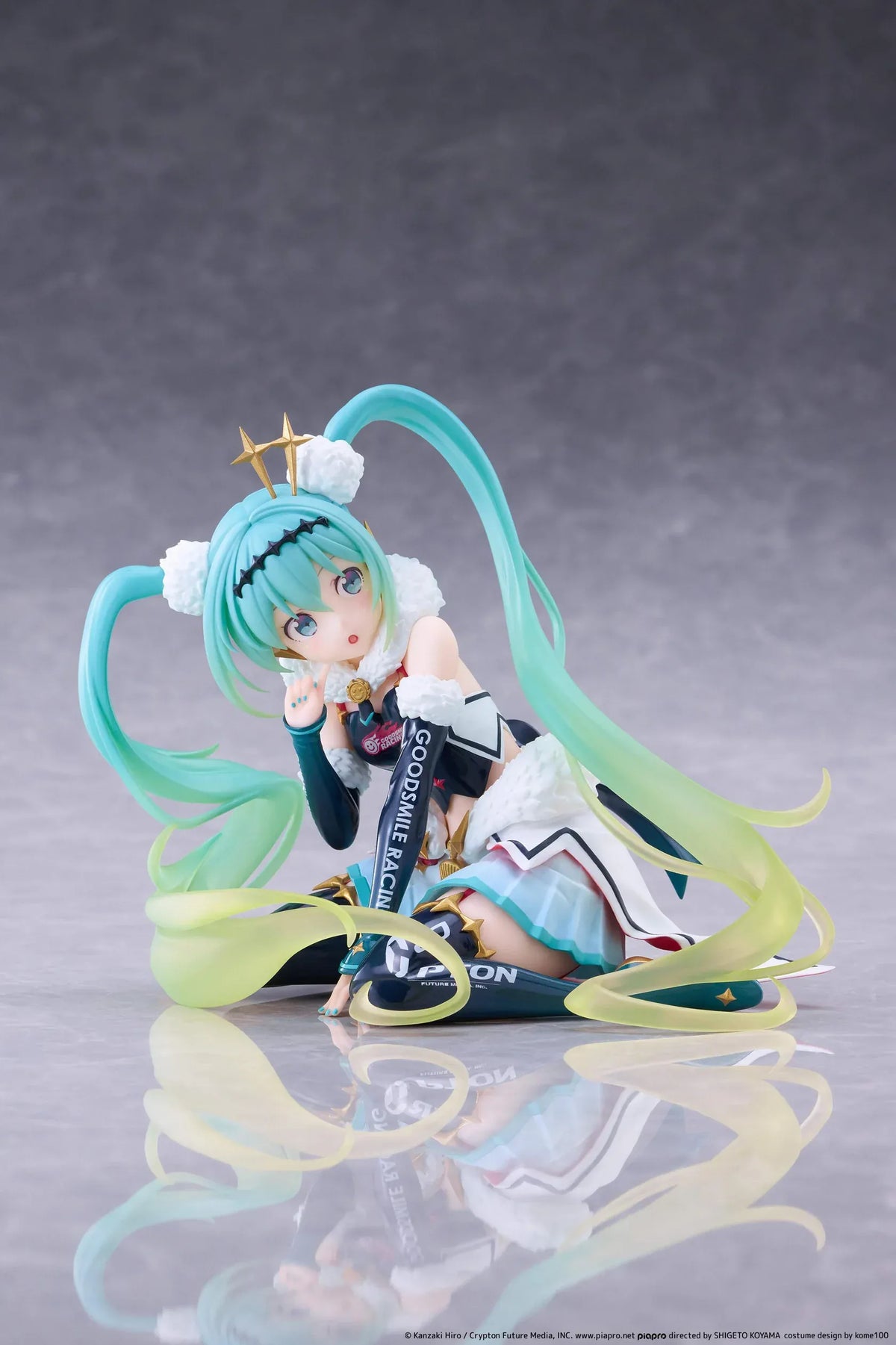 Racing Miku 2018 Ver. Round 8 figure seated in a white, black, and turquoise racing outfit with long gradient twin tails.