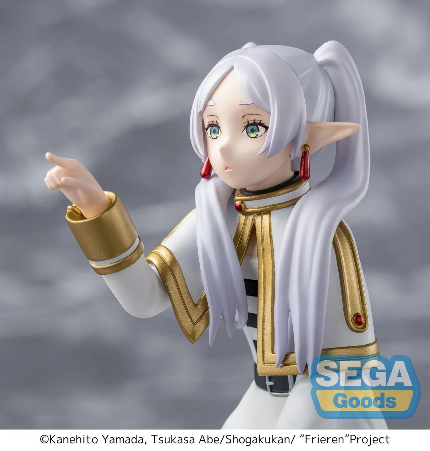 Perching figure of Frieren from Frieren: Beyond Journey’s End kneeling on a stone-like base, reaching forward to poke something, with long silver hair, elf ears, and a white-and-gold outfit.
