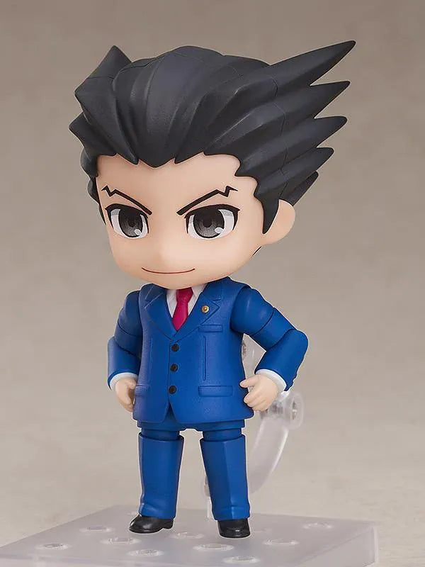 Ace Attorney Phoenix Wright Nendoroid rerelease figure wearing a blue suit and pointing beside a Japanese Objection effect part.