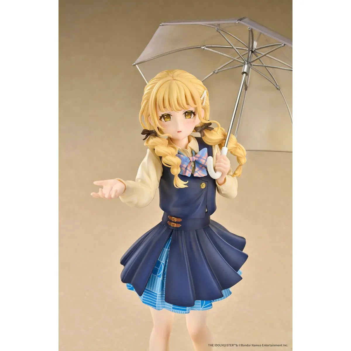 Gakuen iDOLM@STER Kotone Fujita Ameagari no Iris Before Special Training Ver. 1/7 Scale Figure featuring a blonde-haired anime girl with twin braids wearing a navy-blue school uniform and holding a transparent umbrella on a yellow display base.