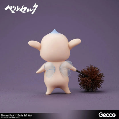 Berserk Chestnut Puck 1/1 Scale Soft Vinyl Figure by Gecco featuring a small cream-colored elf with oversized pointed ears, a tiny blue hair tuft, closed eyes, a grumpy expression, and a rounded body holding a large spiky brown chestnut burr.