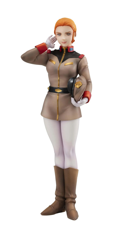 Gundam Girls Generation Matilda Ajan figure saluting in a tan military uniform and peaked cap, holding a green folder, with white trousers and brown boots.