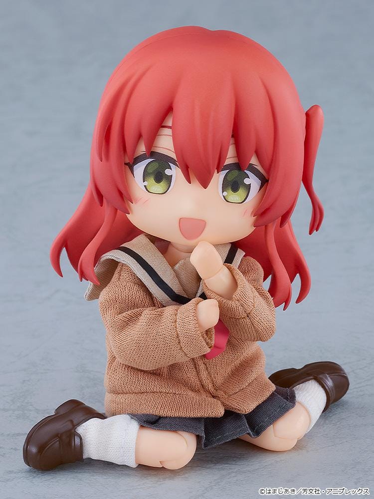 Bocchi the Rock Nendoroid Doll Ikuyo Kita featuring Kita with red hair, green eyes, a fabric cardigan outfit, skirt, socks, and loafers.