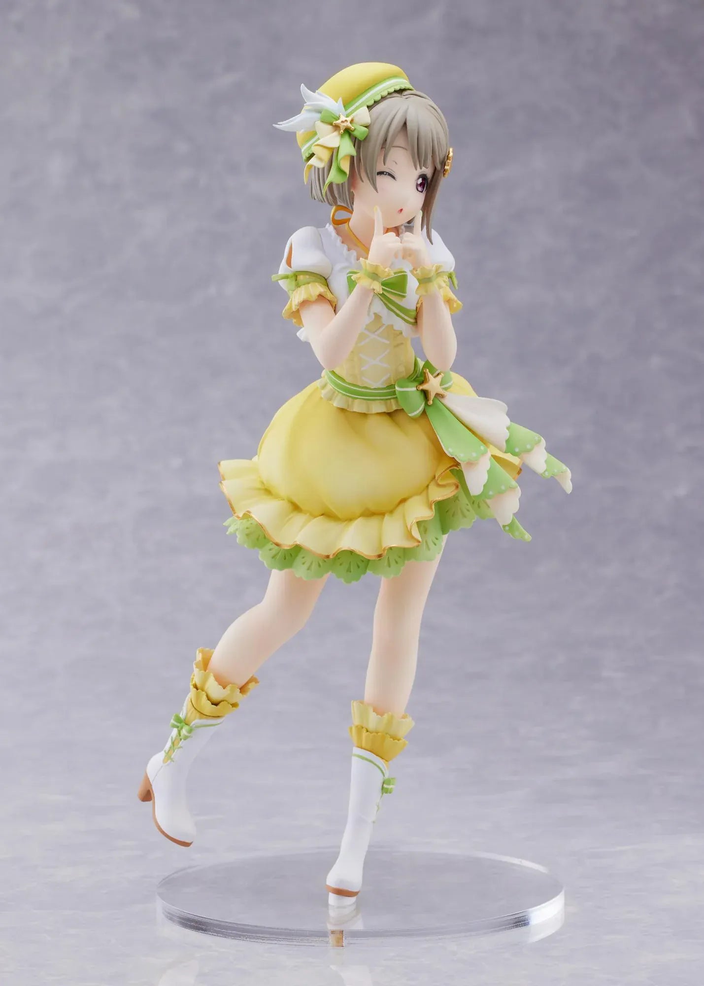 Love Live Nijigasaki High School Idol Club Kasumi Nakasu 1/7 Scale Figure featuring Kasumi in a yellow and green idol outfit with a winking expression, ribbon accents, and matching boots.