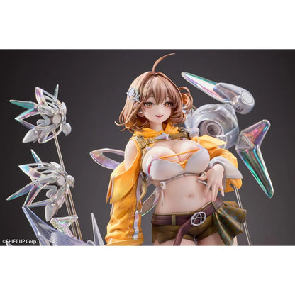 GODDESS OF VICTORY: NIKKE Anis: Star 1/7 Scale Figure featuring a brown-haired anime girl wearing a yellow jacket, white top, olive-green shorts, and sneakers, surrounded by futuristic floating mechanical accessories on a detailed display base.