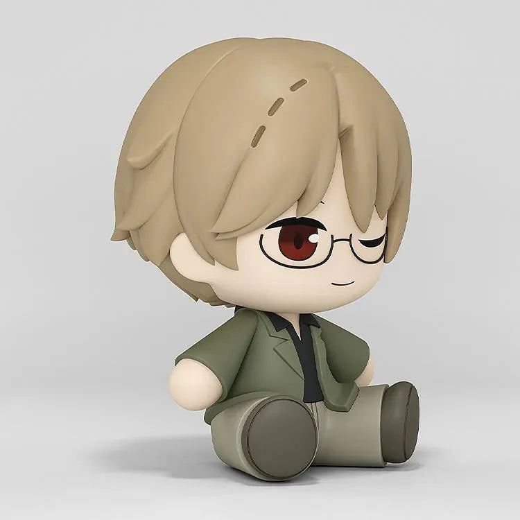 Shuichi Natori Huggy Good Smile figure seated in a green jacket and glasses with a playful winking expression.